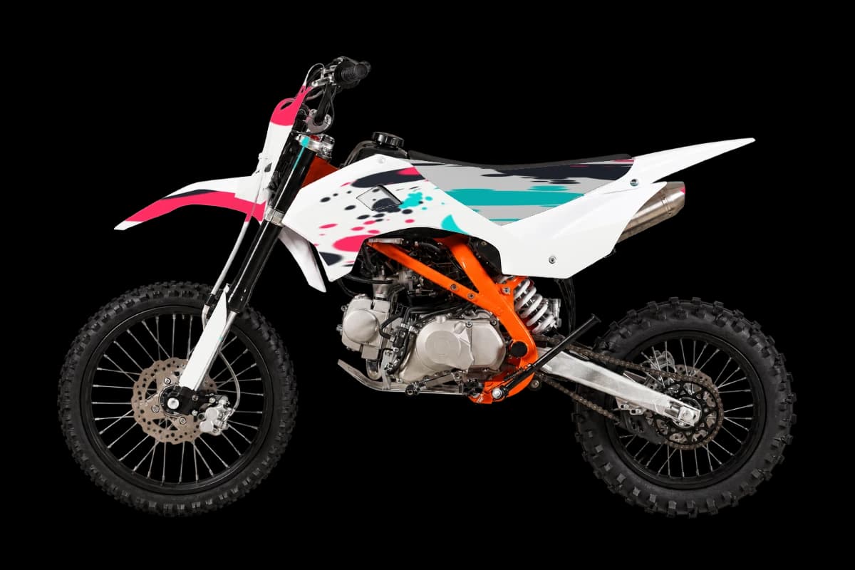 Paint splatter style dirt bike graphics kit on a Kayo TT125